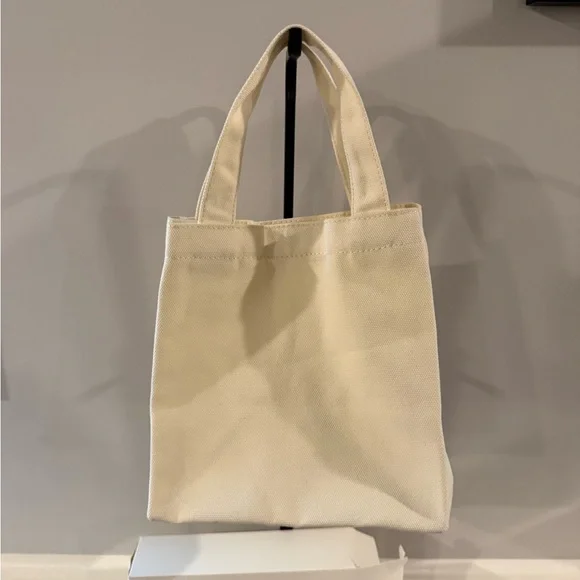 Cream-colored Prada Parfums novelty tote bag. Gift With Purchase - Picture 4 of 5